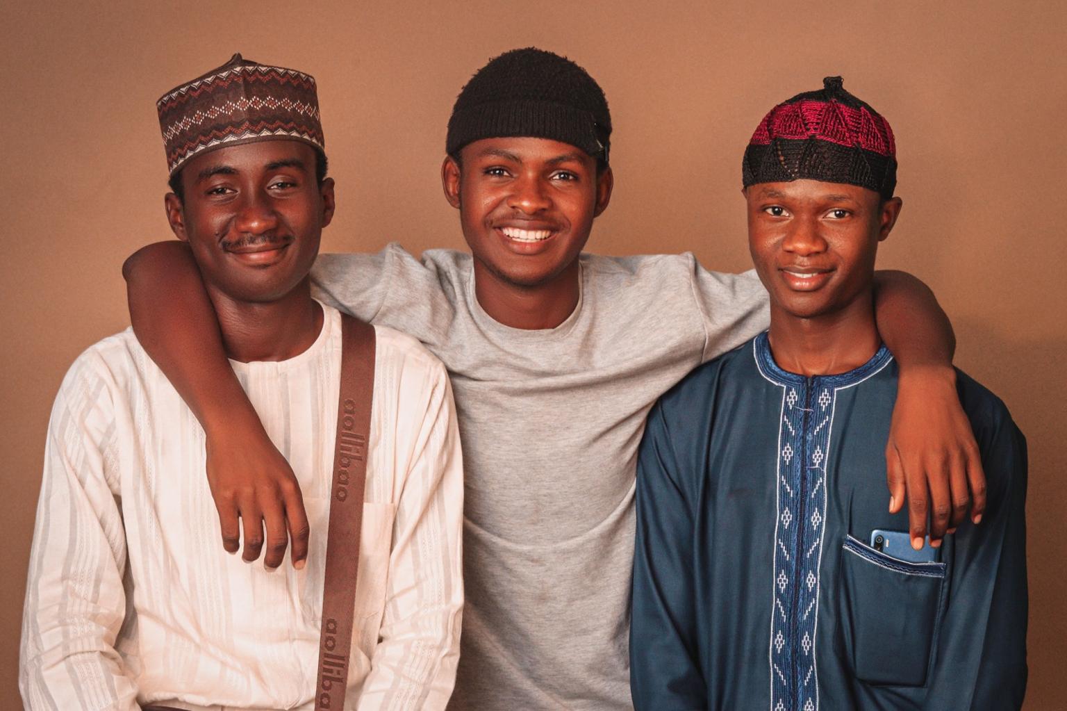 Three young mentees smiling together